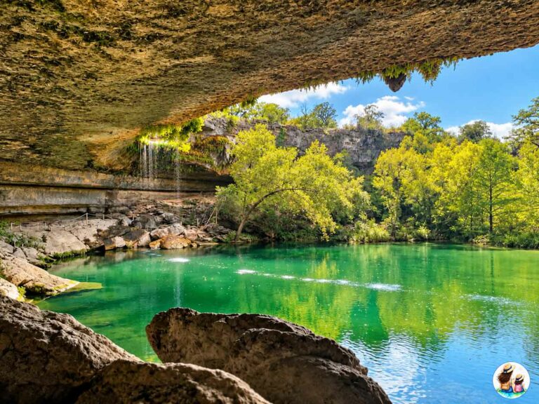Waterfall Spilling Over The Limestone Grotto Into The Green Pool At Hamilton Pool Preserve In Texas