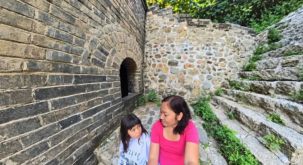Sleeping On The Great Wall Of China: Inside A Watchtower Mother And Daughter By A Great Wall Watchtower In The Early Morning