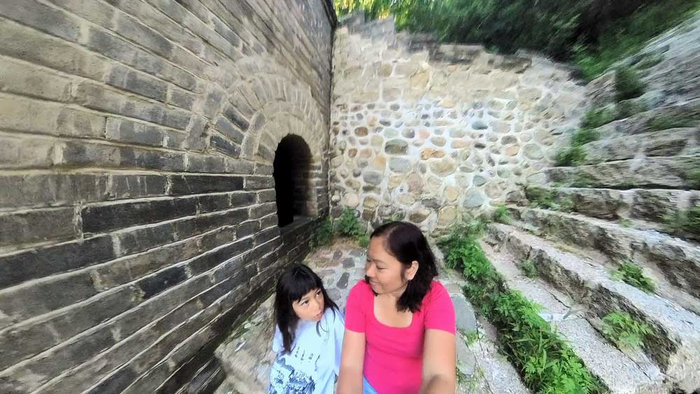 Mother And Daughter With The Great Wall Watchtower In The Early Morning