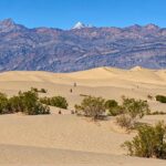 Rolling Sand Dunes And Desert Mountains At Mesquite Flat Sand Dunes In Death Valley National Park.