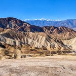 Golden Badlands And Layered Desert Ridges At Zabriskie Point In Death Valley National Park.